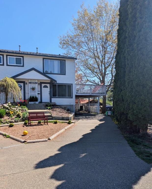 a house with a bench in front of it at Ashwood monthly in Courtenay