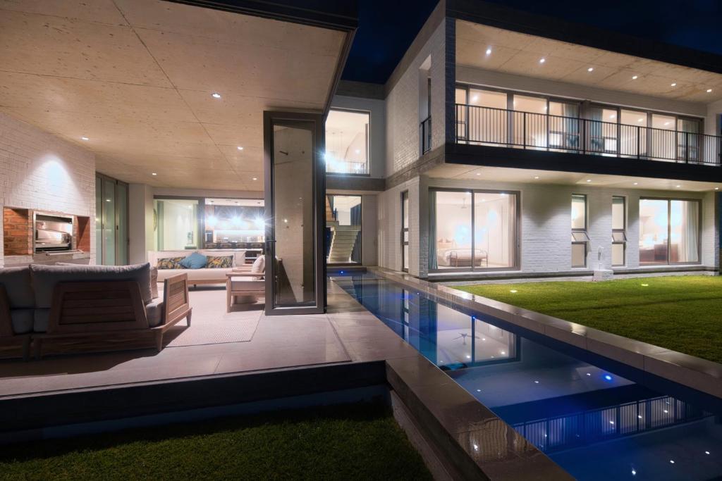 a house with a swimming pool in front of it at Sonvanger Villa Struisbaai in Struisbaai