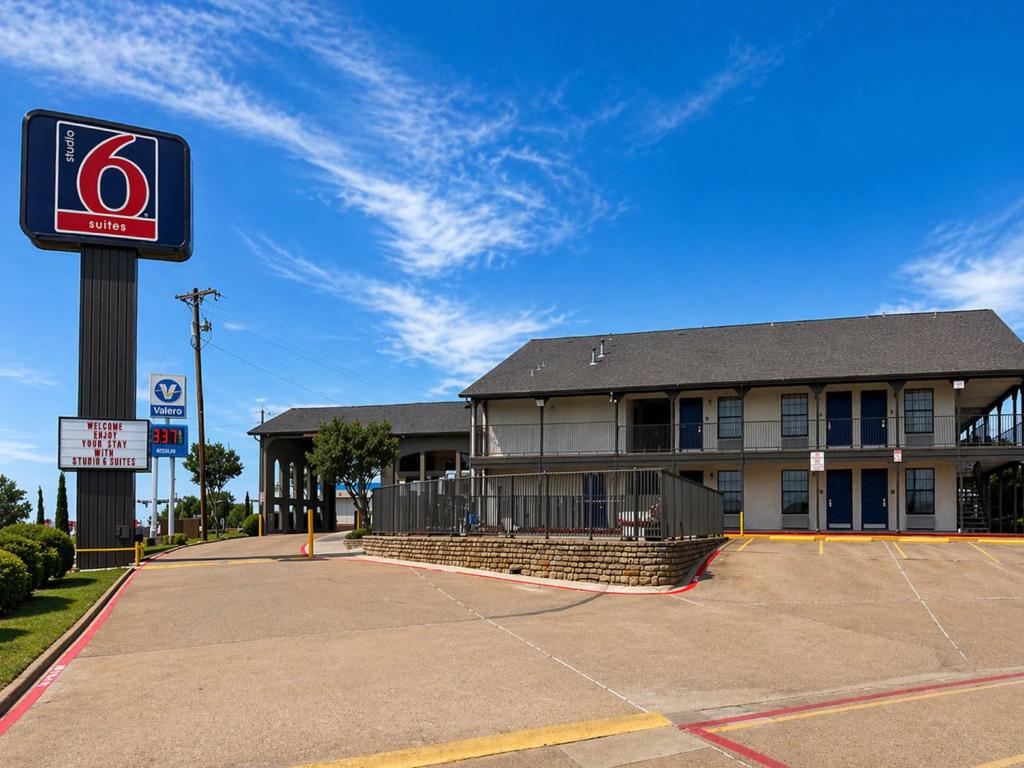 a building with a basketball court in front of it at Studio 6 Suites Mesquite, TX – Gross Rd. in Mesquite