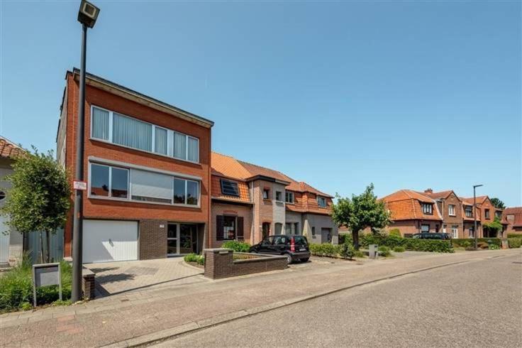 a building with a car parked on the side of a street at CoSY HOME in Mortsel