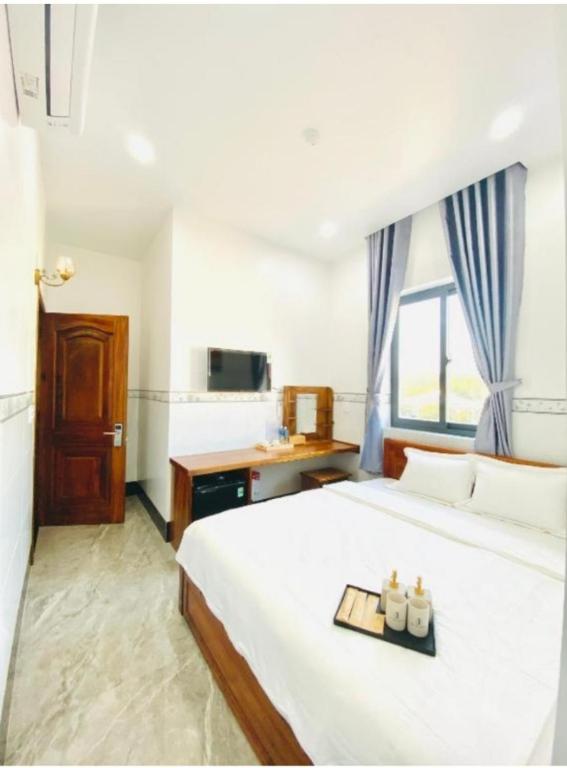 a bedroom with a bed with a tray of candles on it at Moonlight House in Cu Lao Thu