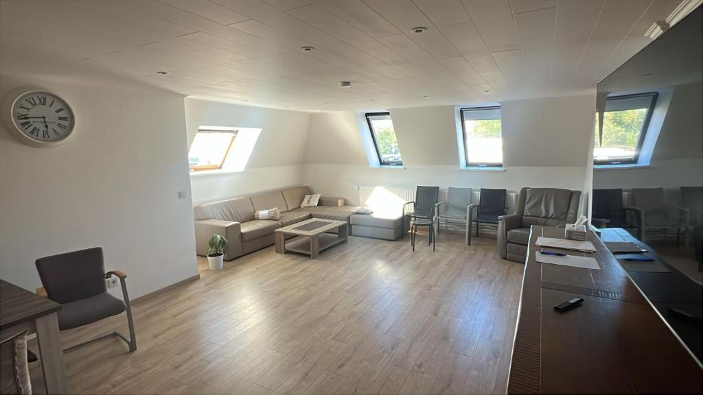 a living room with a couch and a table at Kampenhout appartement met terras en 4 slaap kamers in Kampenhout
