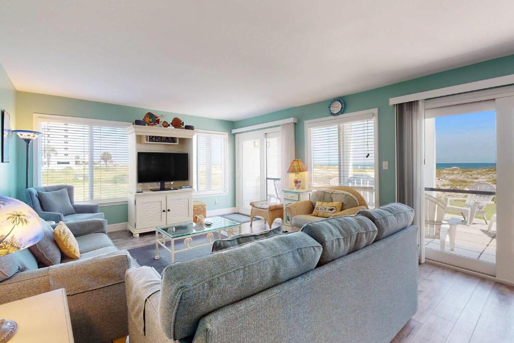 a living room with a couch and a television at #1131 The Mermaid Pad in Gulf Highlands