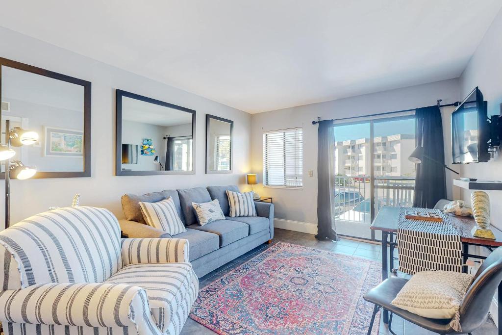 a living room with a couch and a table at Plantation East #1110 in Gulf Shores