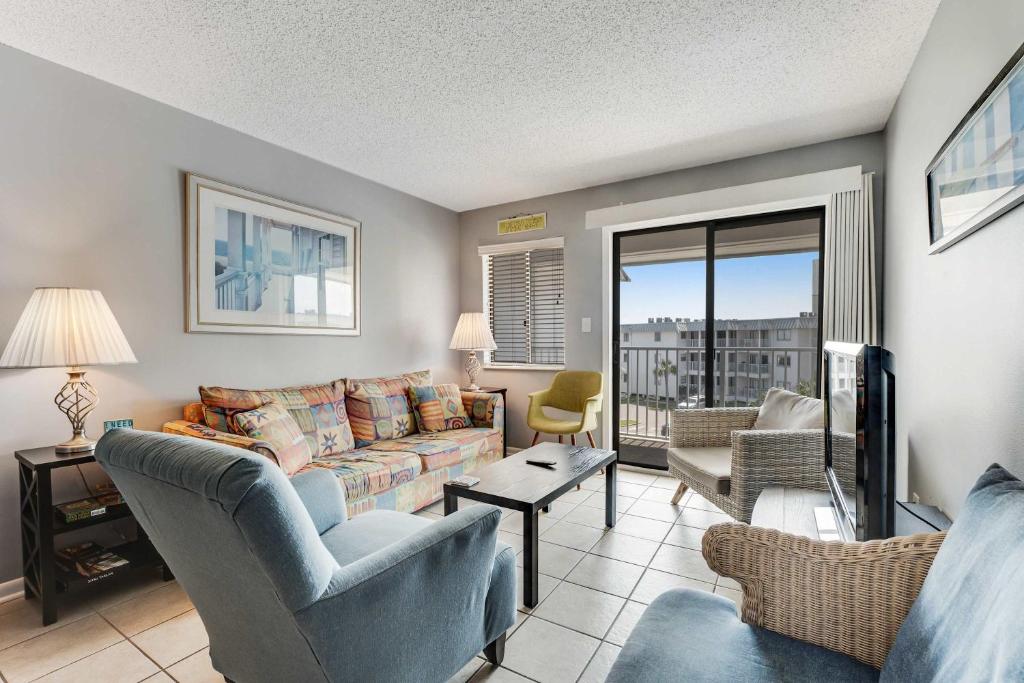 a living room with a couch and a tv at Plantation East #2314 in Gulf Shores