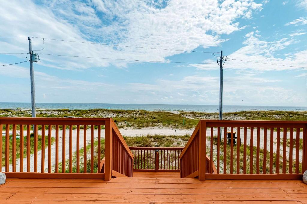a wooden deck with a view of the beach at Fine Fish House in Gulf Highlands