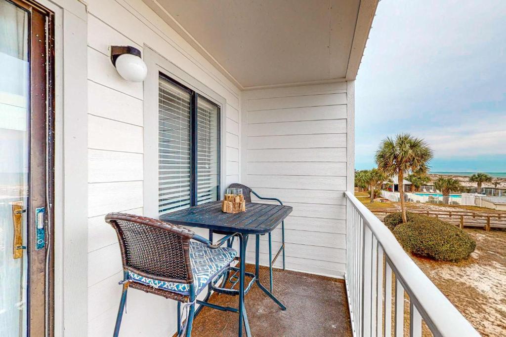 a table and chairs on the balcony of a house at Plantation East 2205 in Gulf Shores