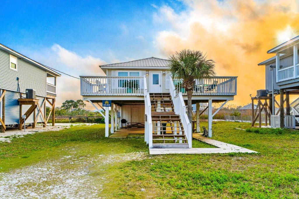 a house with a staircase leading up to a house at Blue Marlin in Gulf Shores