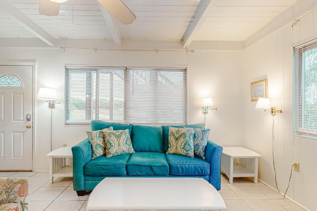 a living room with a blue couch and two tables at Campbellot by Meyer Vacation Rentals in Fort Morgan