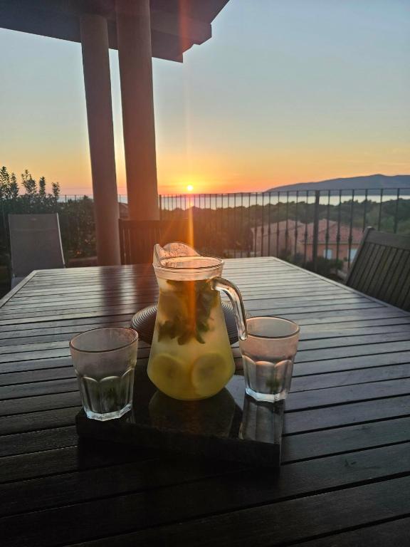 a pitcher of lemonade on a tray with two glasses at Valinco Locations OLMETO PLAGE in Olmeto