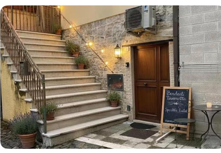 a staircase with potted plants in front of a building at La Tavernetta in Pietra Montecorvino