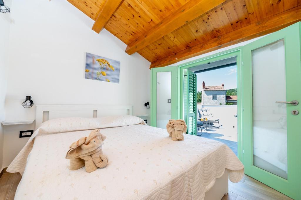 a bedroom with two stuffed animals sitting on a bed at Sant'Antonio in Orlec