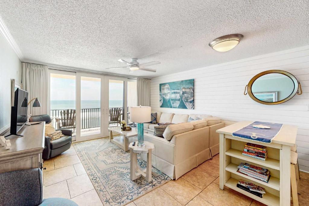 a living room with a couch and a table at Gulf-front condo with breathtaking views pool in Orange Beach