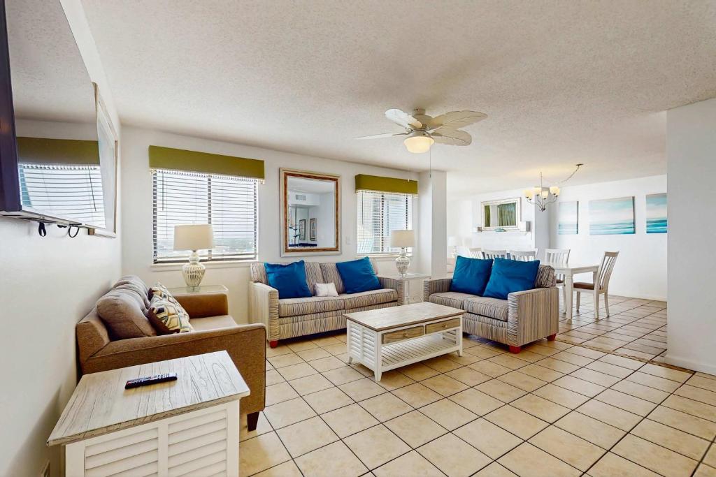 a living room with couches and a table at The Whaler 7B in Gulf Shores