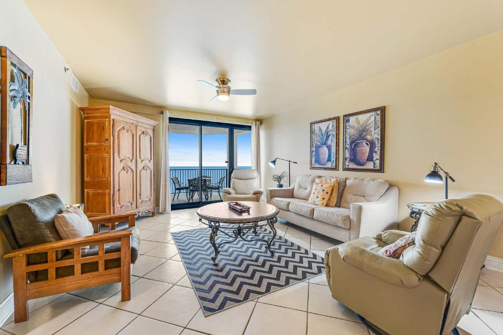 a living room with a couch and a table at Broadmoor 604 in Orange Beach