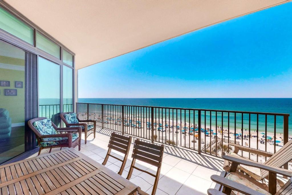 a balcony with chairs and a view of the beach at Phoenix West 502 in Orange Beach