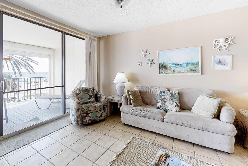 a living room with a couch and a chair at Pelican Pointe 302 in Orange Beach