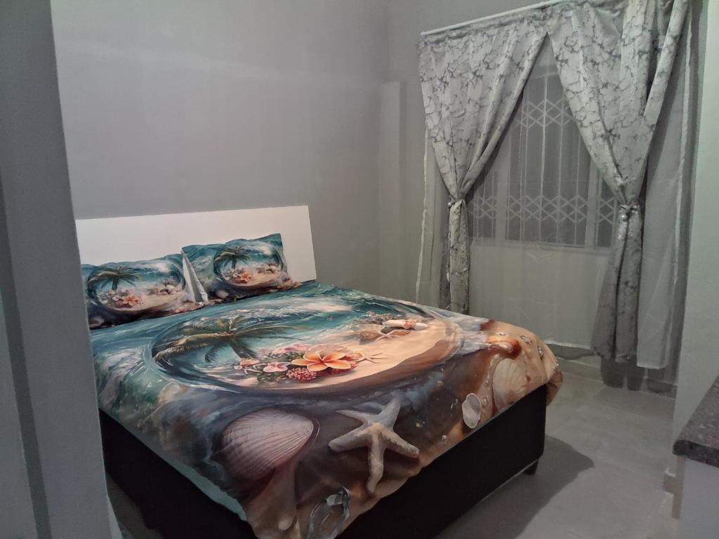 a bedroom with a bed with a painting of an octopus at Cozy suburban guest house - Durban in Verulam