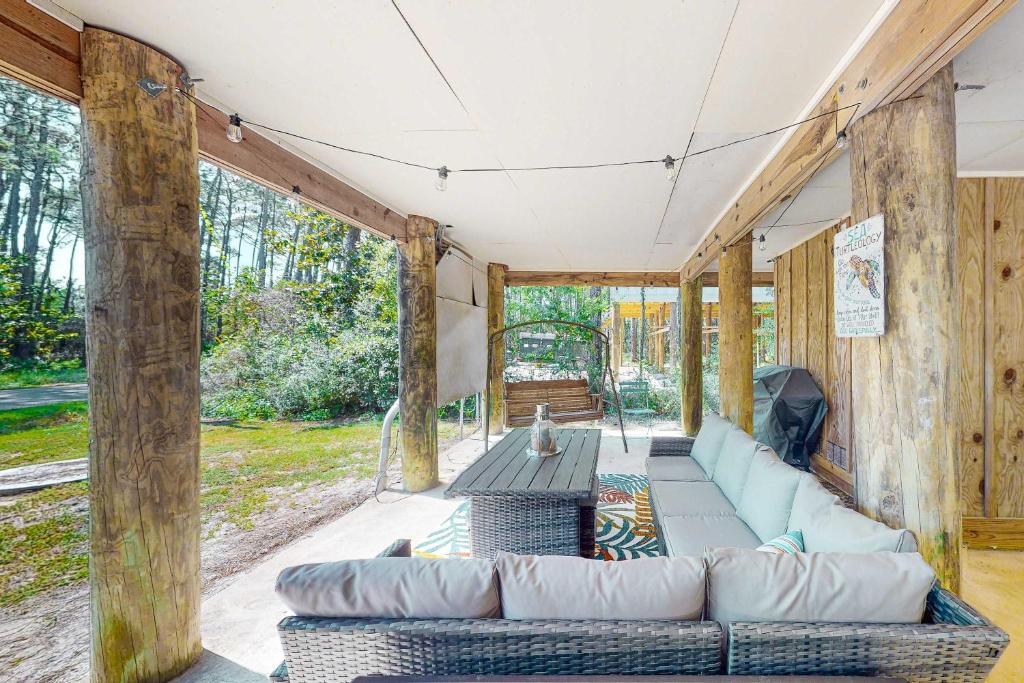 a living room with a couch and a table at Sunset Breeze #4 in Dauphin Island