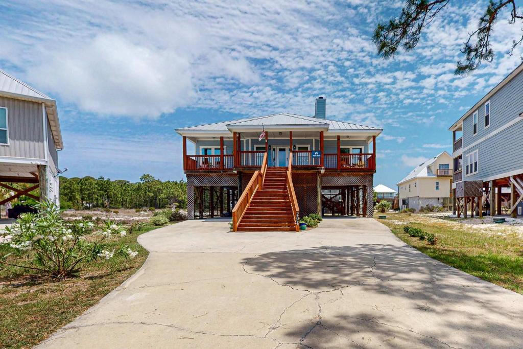 a house with a staircase leading up to it at Bale Oasis in Dauphin Island