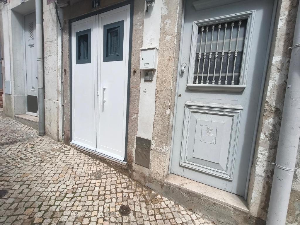 a pair of doors on the side of a building at Estúdio Madragoa in Lisbon