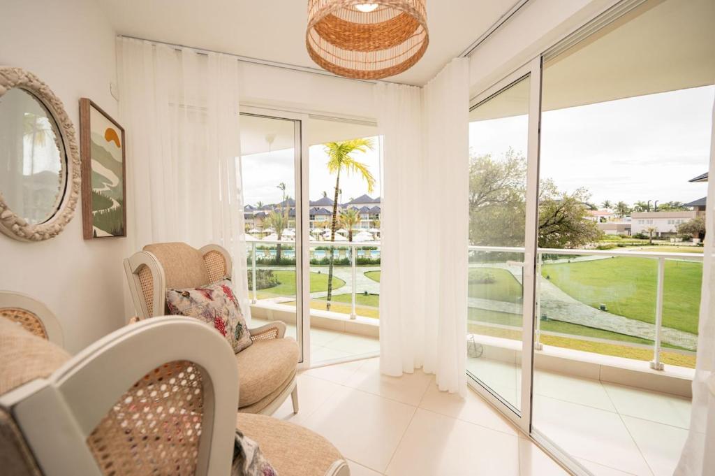 a living room with a view of a golf course at Caribbean Beachfront Resort in Puerto Plata