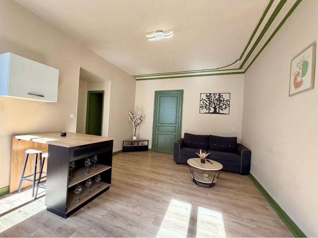a living room with a couch and a table at Appartement Martell in Cognac