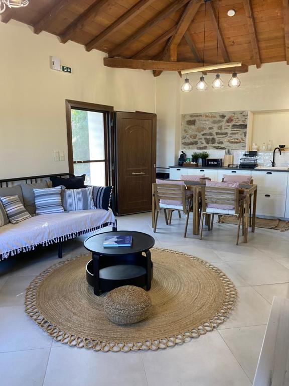 a living room with a couch and a table at Koumara Stone House in Koútsi