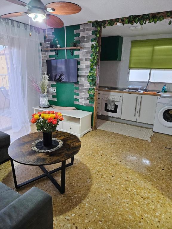 a living room with a table and a kitchen at Sky Apartment in Miramar