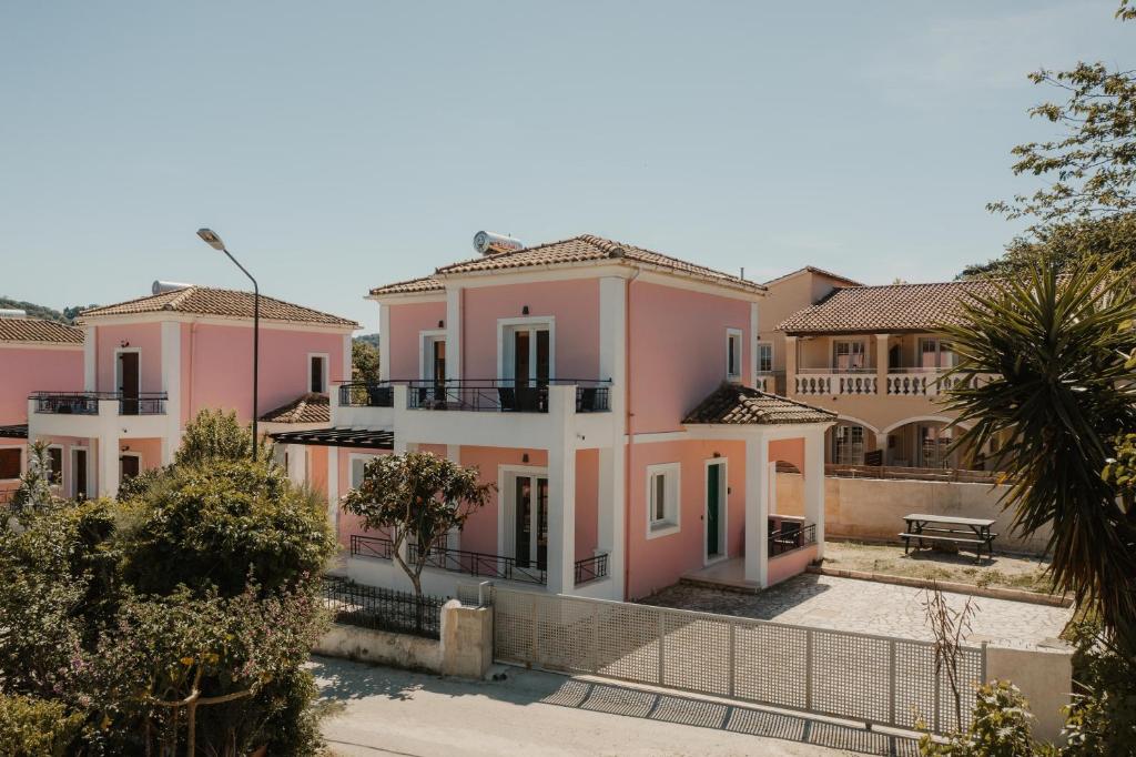 a row of houses with pink at Mariu Canal d' Amour in Melíssia