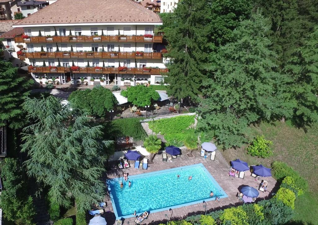 an aerial view of a hotel with a swimming pool at Hotel Miralago Wellness - Adults Only in Molveno