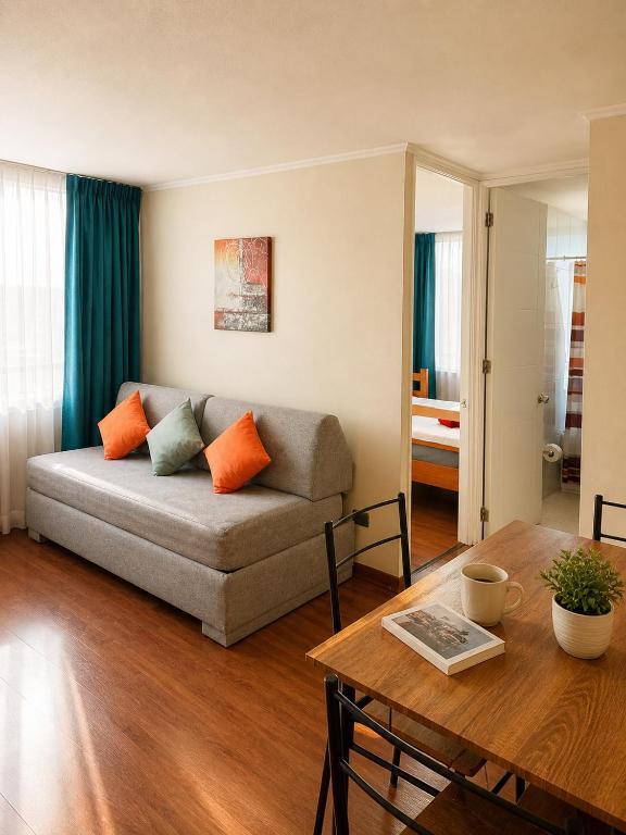 a living room with a couch and a table at Departamentos Amoblados Torre Tagle in Santiago