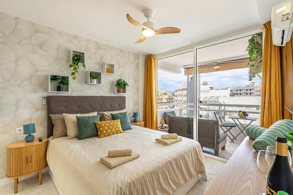 a bedroom with a large bed and a large window at Magic View Costa Adeje in Costa de Adeje