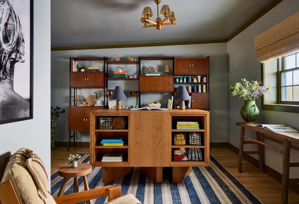 a living room with a desk and a book shelf at Hotel Corduroy in Montauk