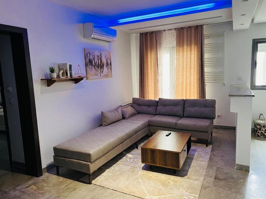 a living room with a couch and a coffee table at Modern Oasis near Airport & Lac 2 - Wahat Aouina in El Aouina Station