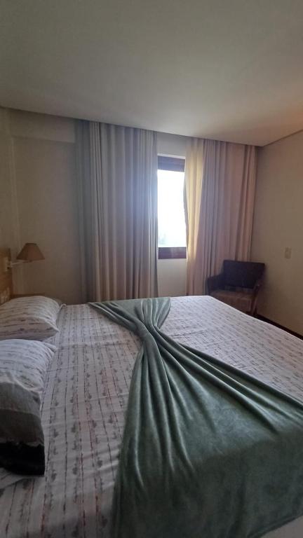 a large bed in a bedroom with a window at Kariri Beach Waterfront Retreat in Caucaia