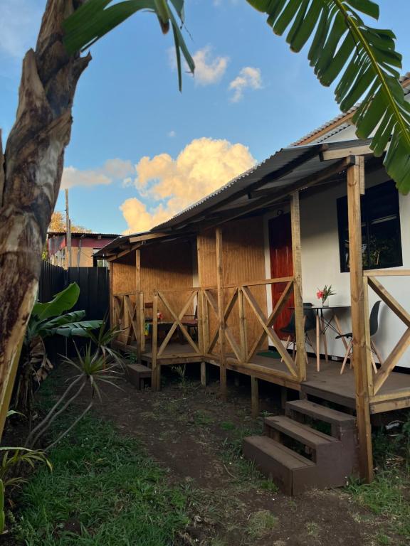 a house with wooden doors and a porch at Hospedaje Maika Rapa Nui in Hanga Roa