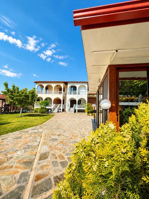 a building with a stone walkway in front of it at Villa Pilgrimos in Ierissos