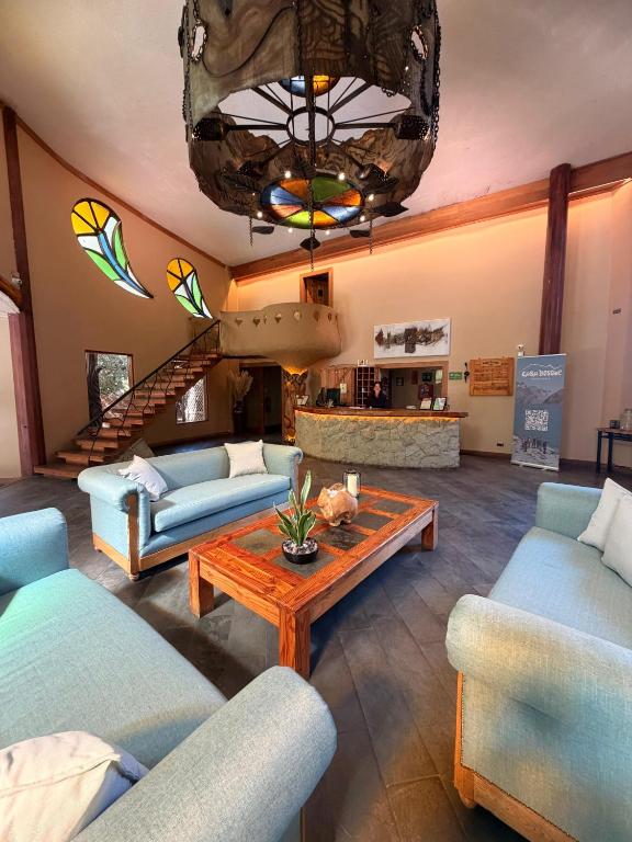 a living room with couches and a coffee table at Casa Bosque Lodge in San José de Maipo