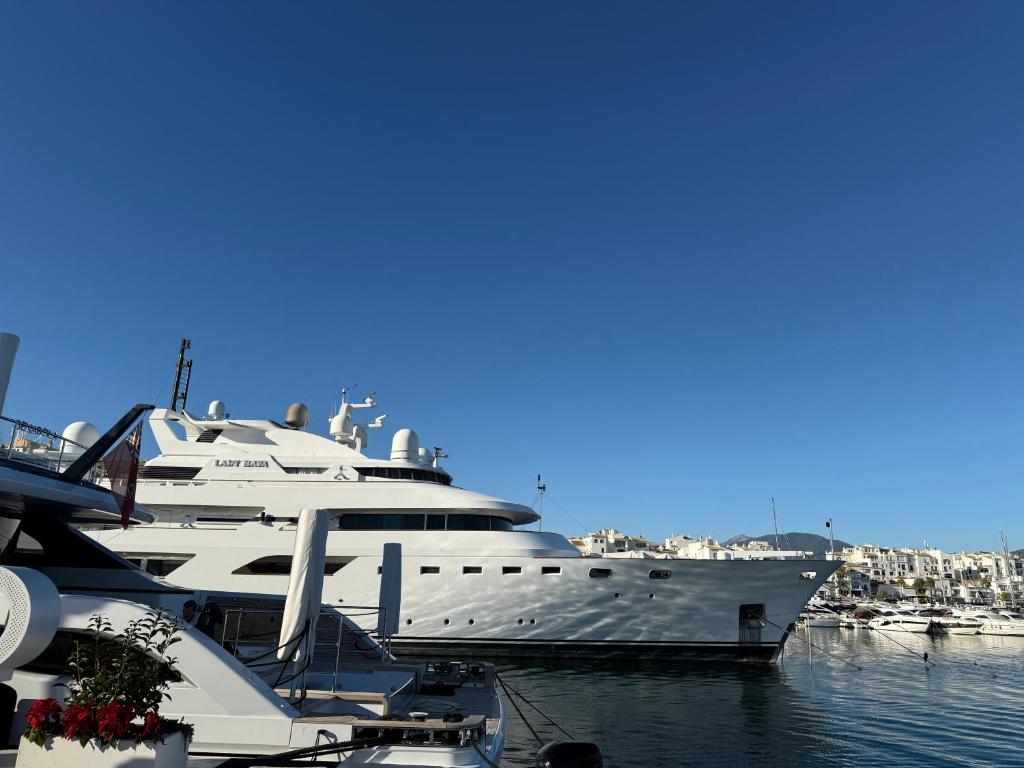 a large yacht is docked in a harbor at costa blanca marbella in Marbella
