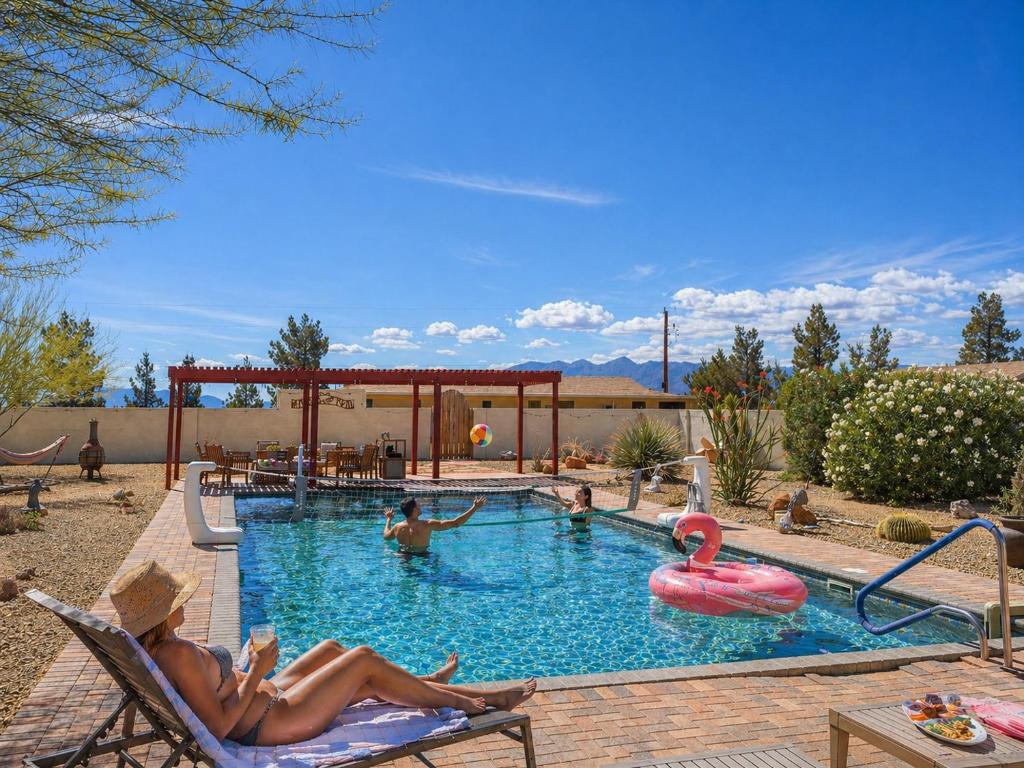 a woman laying in a chair in a swimming pool at Falcon Cottage in Pahrump