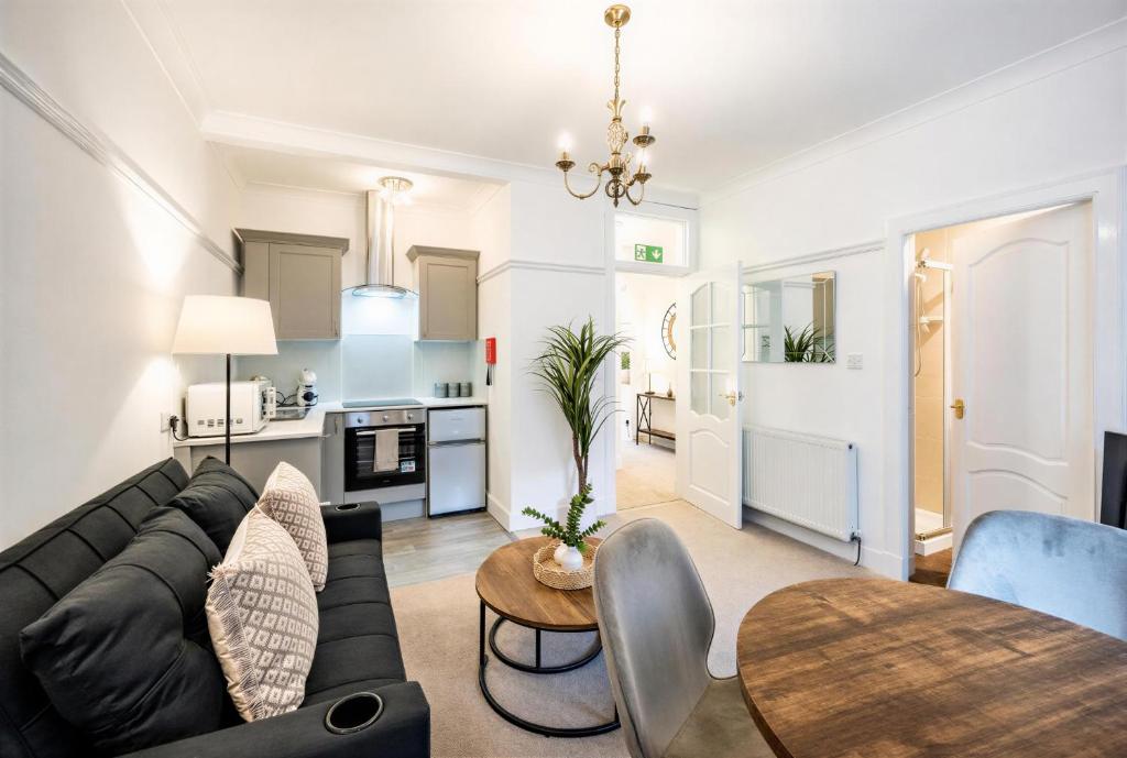 a living room with a couch and a table at Coastal Nest - Cosy flat in Irvine town centre - 5 minute drive from beach in Irvine