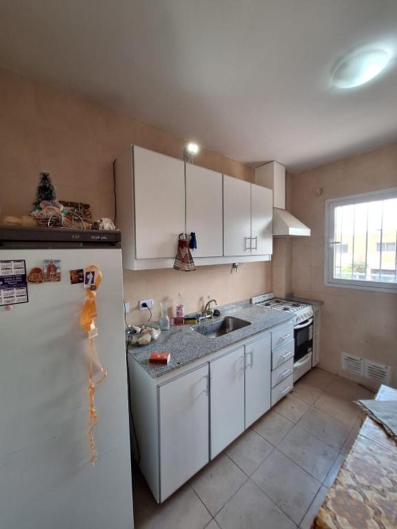 a kitchen with white cabinets and a white refrigerator at Complejo la Superiora in Villa Krause
