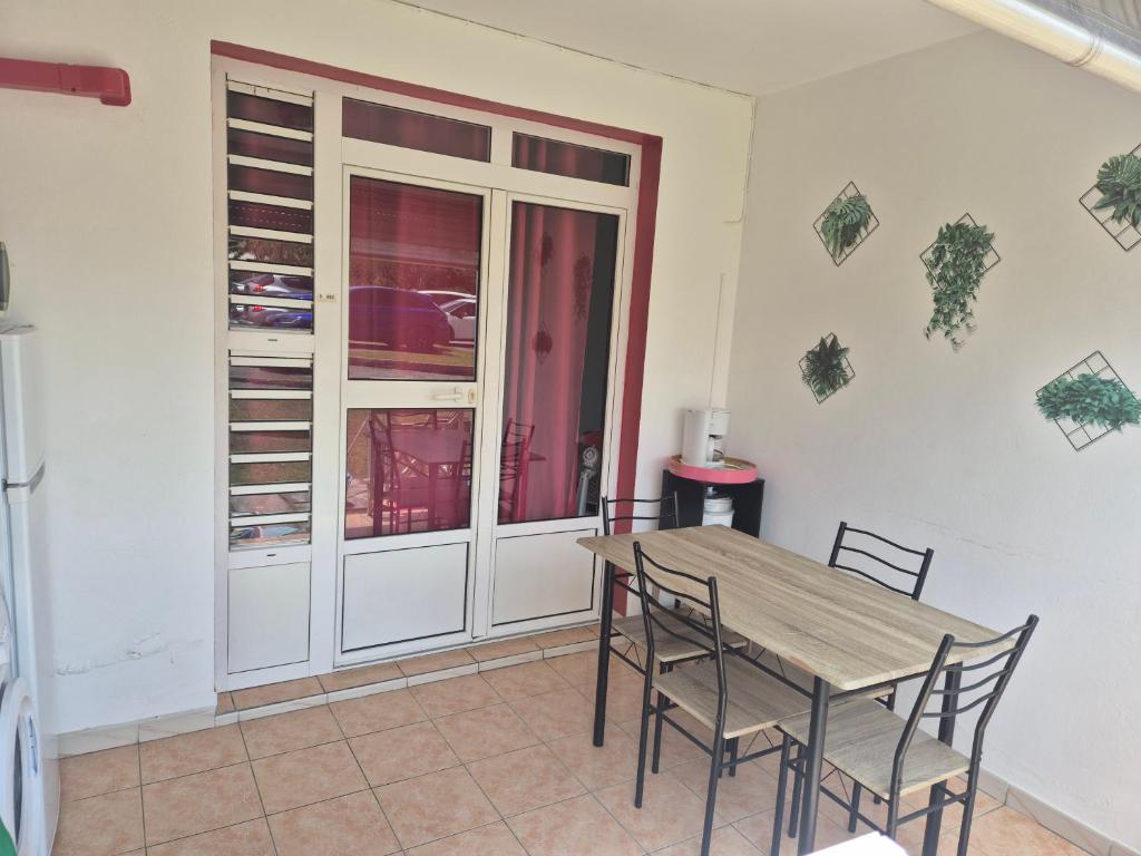 a dining room with a table and chairs at Residence le bounty in Sainte-Luce