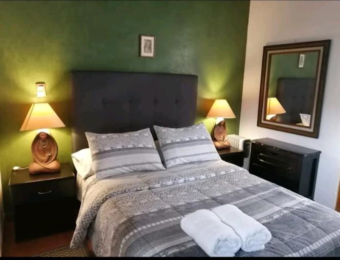 a bedroom with a bed with two towels on it at CHIK Coatepec Comfort in Coatepec