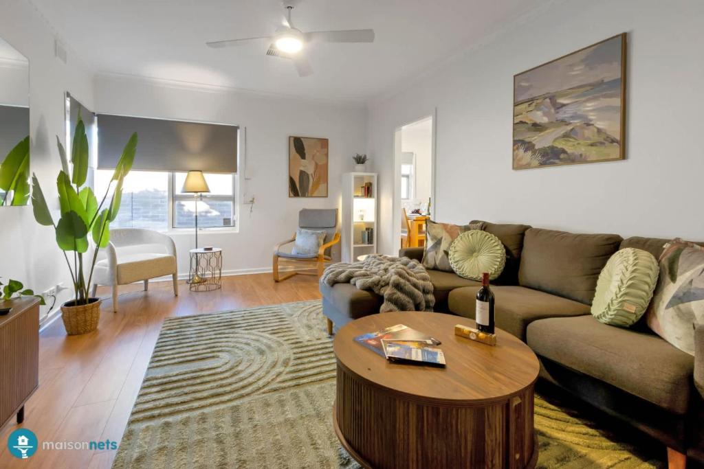 a living room with a couch and a coffee table at Beachside Largs Bay Pet Friendly 3 Bed Haven in Birkenhead