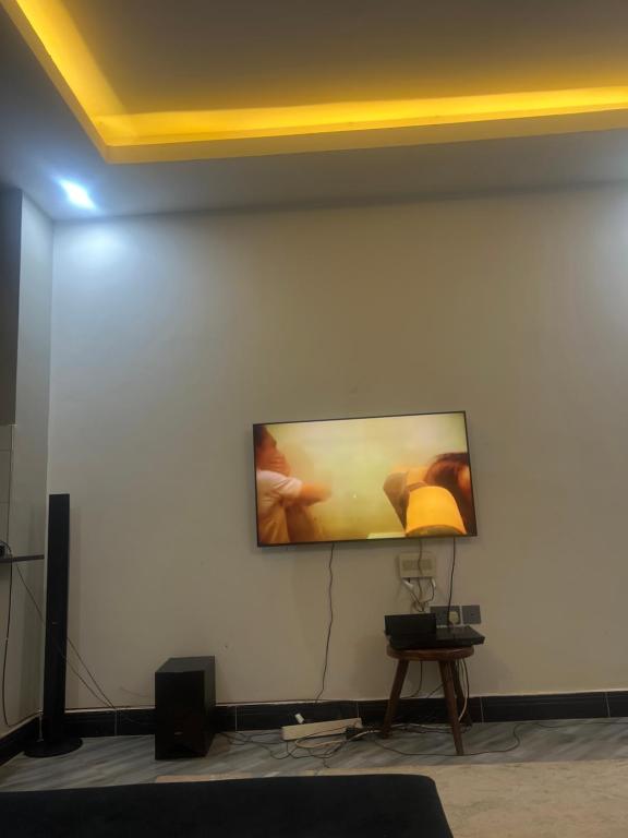 a flat screen tv on a white wall at AJ Space in Kampala