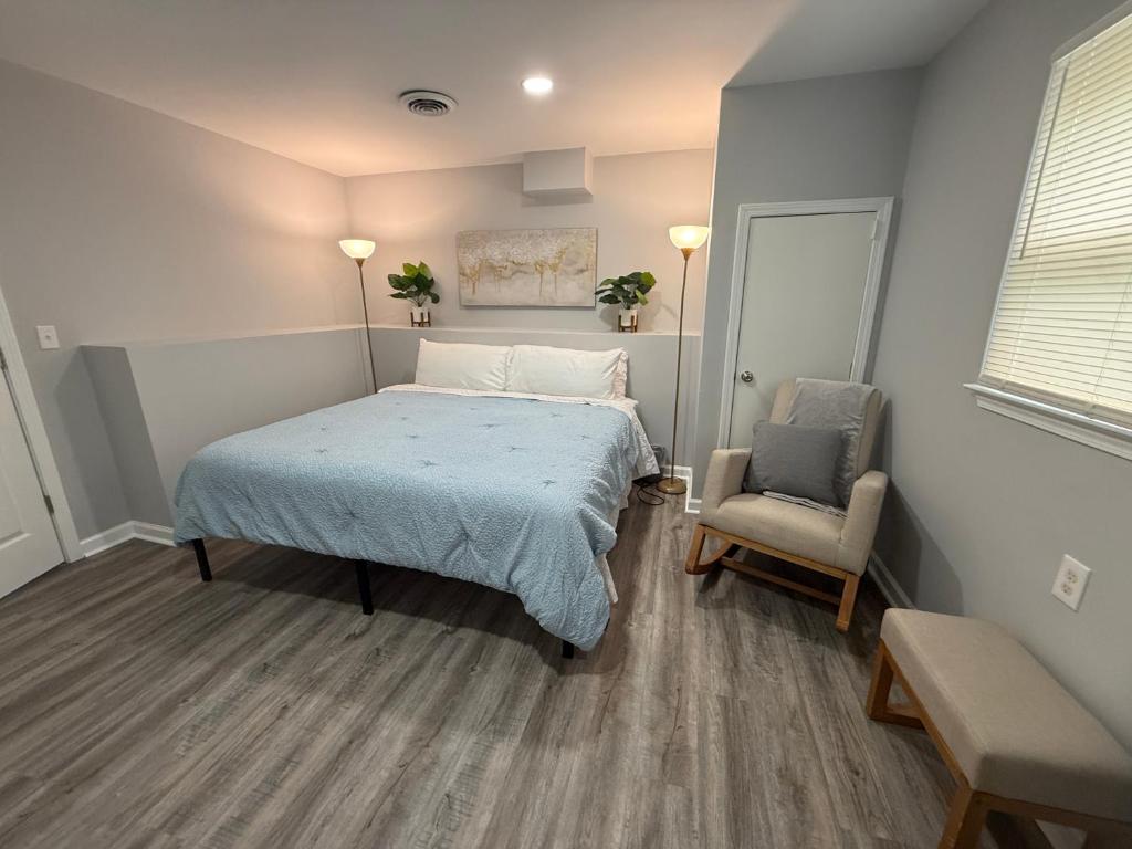 a bedroom with a bed and a chair in it at Cozy and Chic Burlington Retreat in Burlington