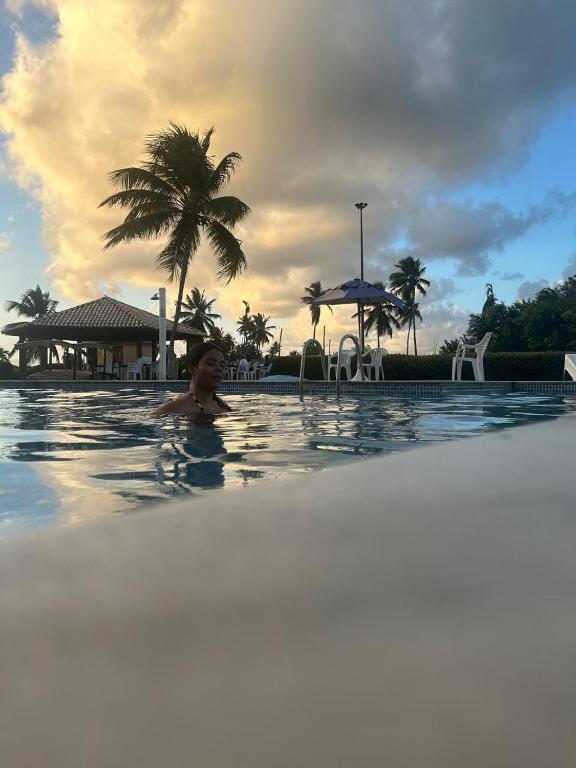 a person in a swimming pool at a resort at GAVOA Beach FLAT in Água Boa