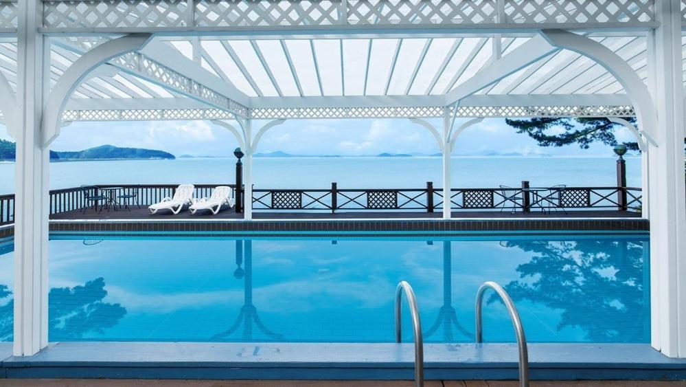 a swimming pool with a view of the water at Taean Supsogui Bada Pension in Panggal-li
